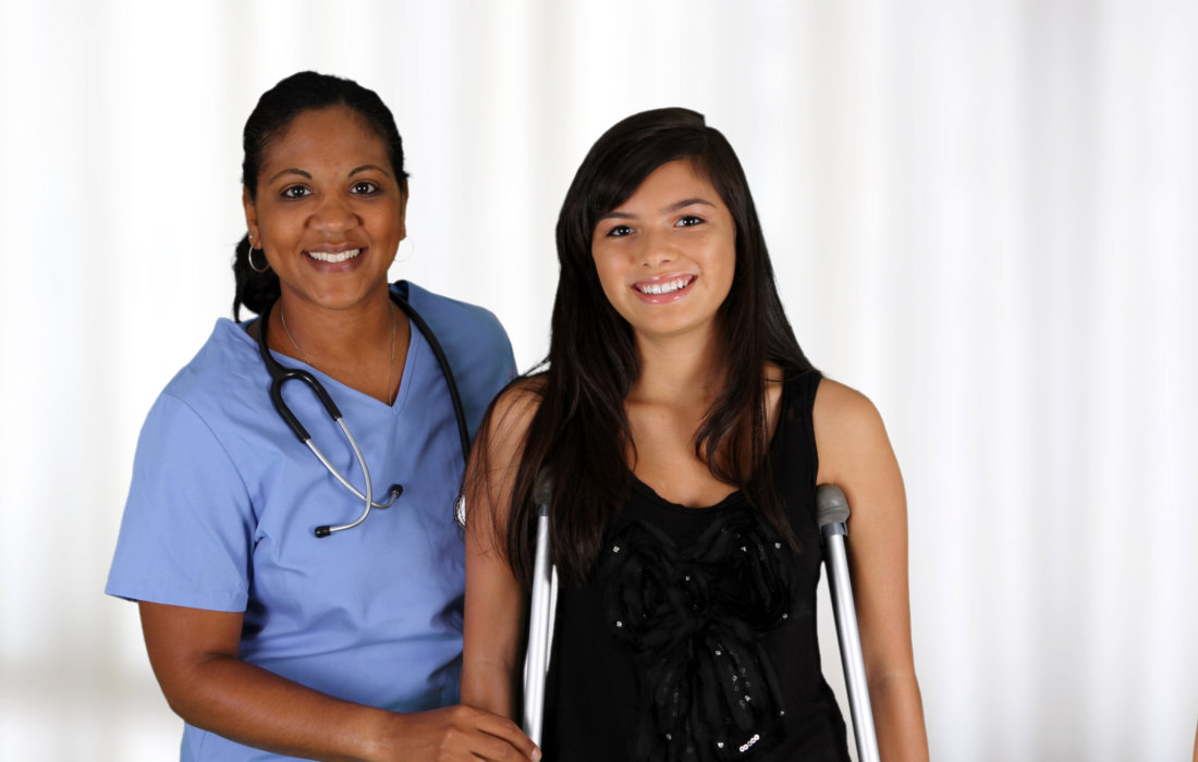 nurse and a teenage patient smiling