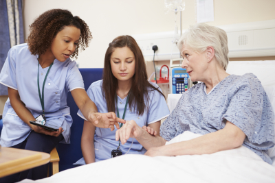 two nurses assisting the patient